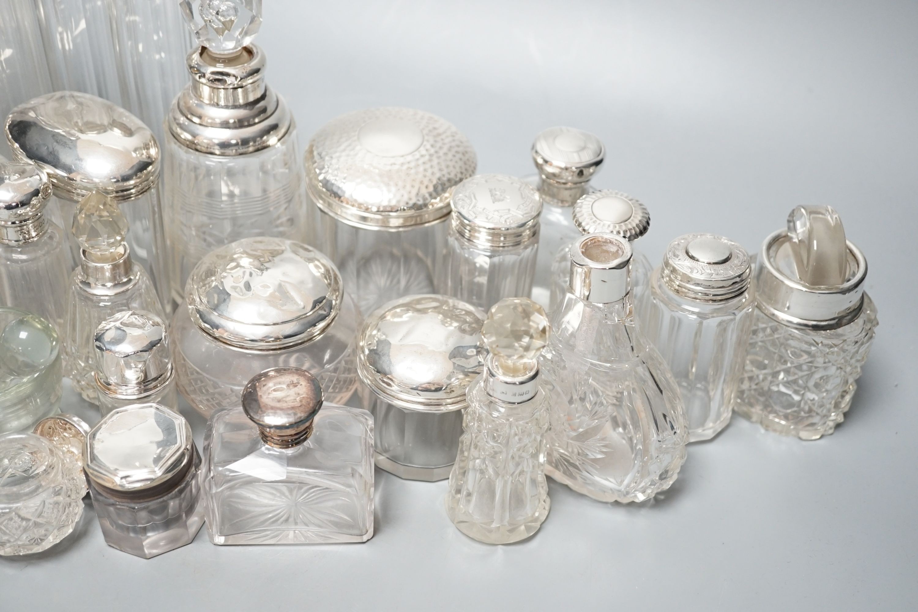 A collection of assorted mainly silver-capped scent bottles and toilet bottles.